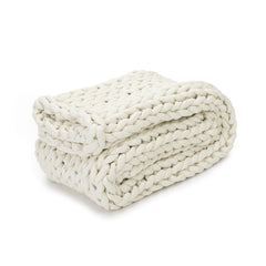 Folded Nuzzie blanket on white background. #Color_Cream