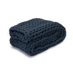 Folded up Nuzzie blanket on white background. #Color_Dusty-Blue