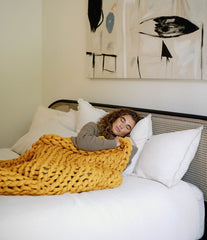 Woman napping in bed with blanket #Color_Marigold